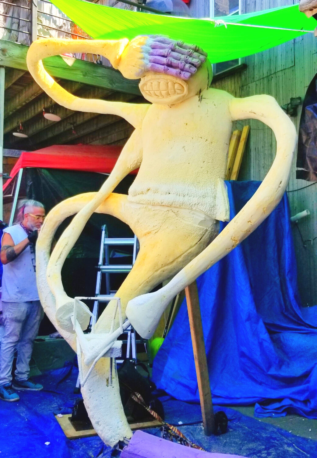 Work in progress - the artist stands beside his eight foot sculpture