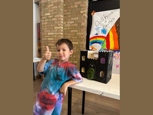 Posing with a creation at Easel Art Studio's summer camp 